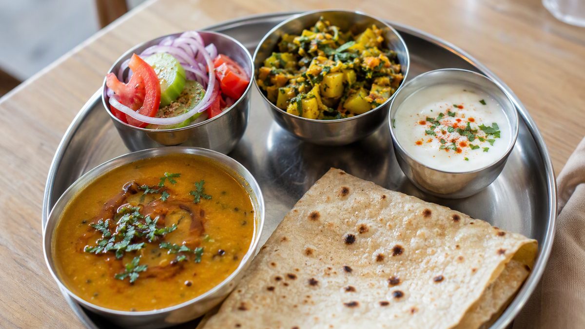 Balanced Indian thali with dal, sabzi, roti, salad and curd