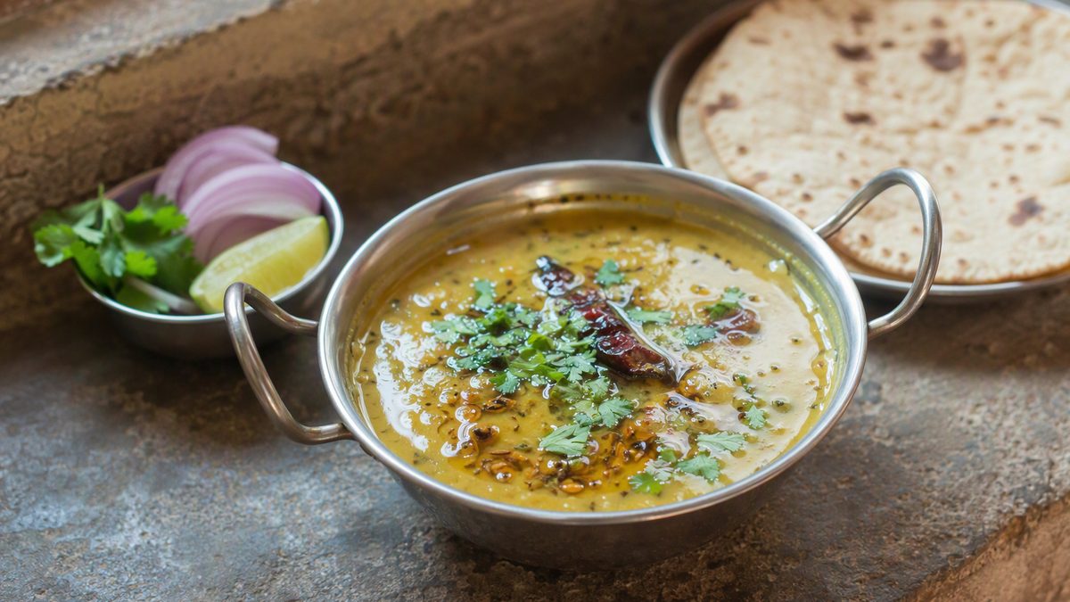Katori of dal tadka with ghee tempering, roti on the side