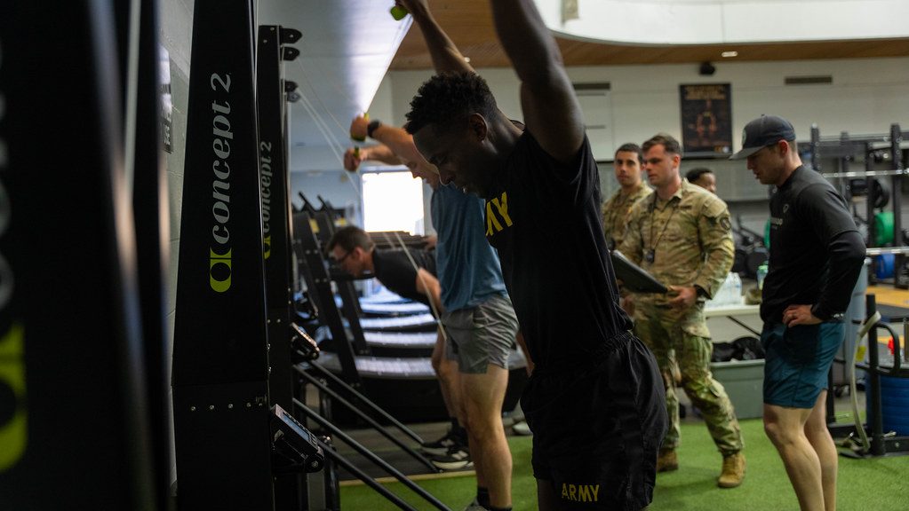 Athlete performing a heavy sled push at a Hyrox competition